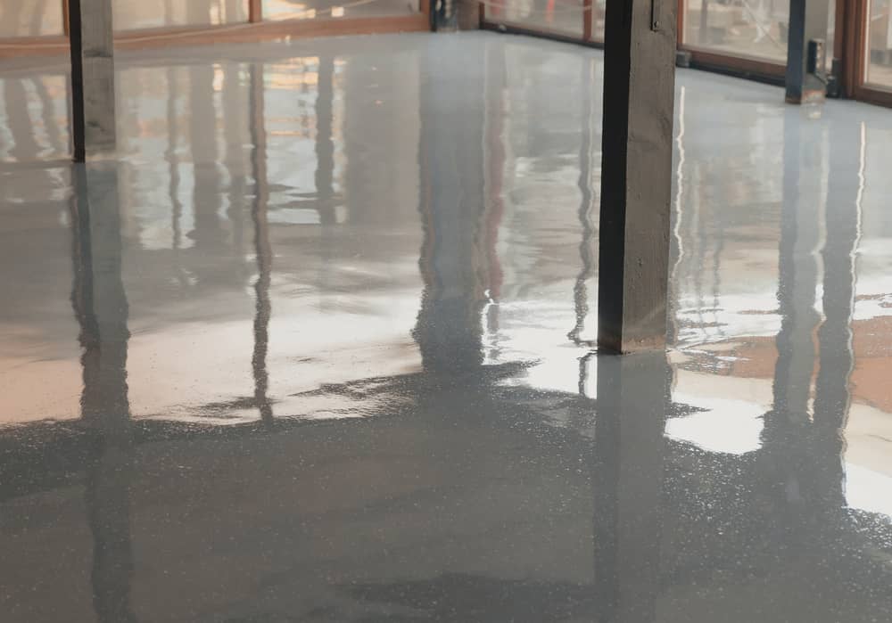 Clean epoxy floor reflecting lights from nearby windows