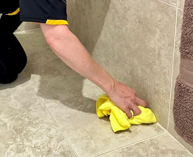 Maid2Match-professional-cleaner-cleaning-floor-tiles professional cleaner wiping floor tiles