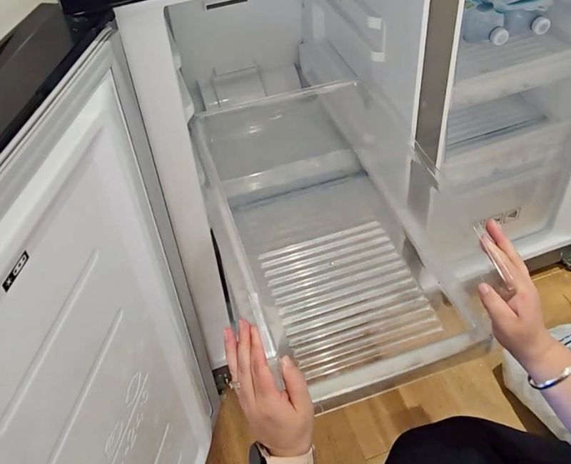 Maid2Match Geelong professional house cleaner cleaning a freezer drawer