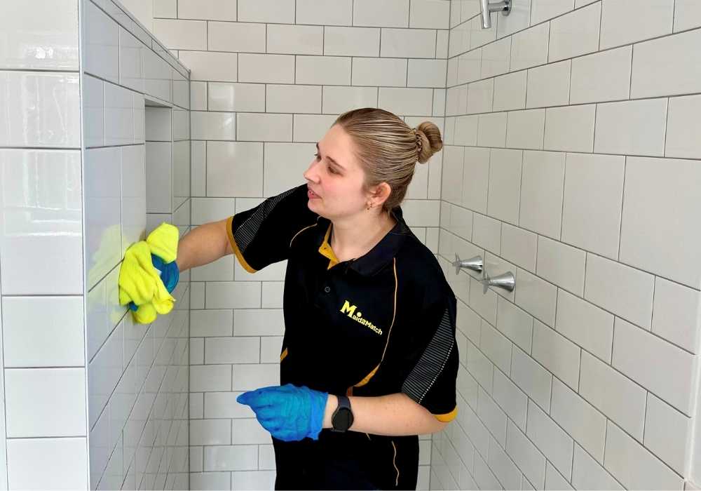 Brisbane-house-cleaner-Kate-lyn-wiping-shower-tiles Maid2Match Brisbane Professional House Cleaner Kate-lyn cleans shower tiles with microfibre cloth