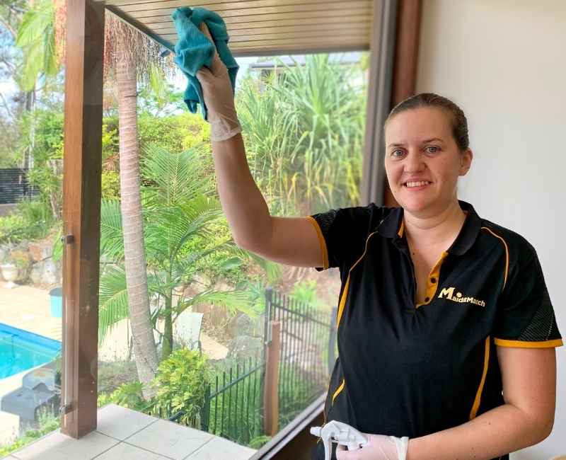 Maid2Match-Brisbane-employee-house-cleaner-cleaning-glass-window Maid2Match Brisbane professional cleaner Nikita cleaning glass window