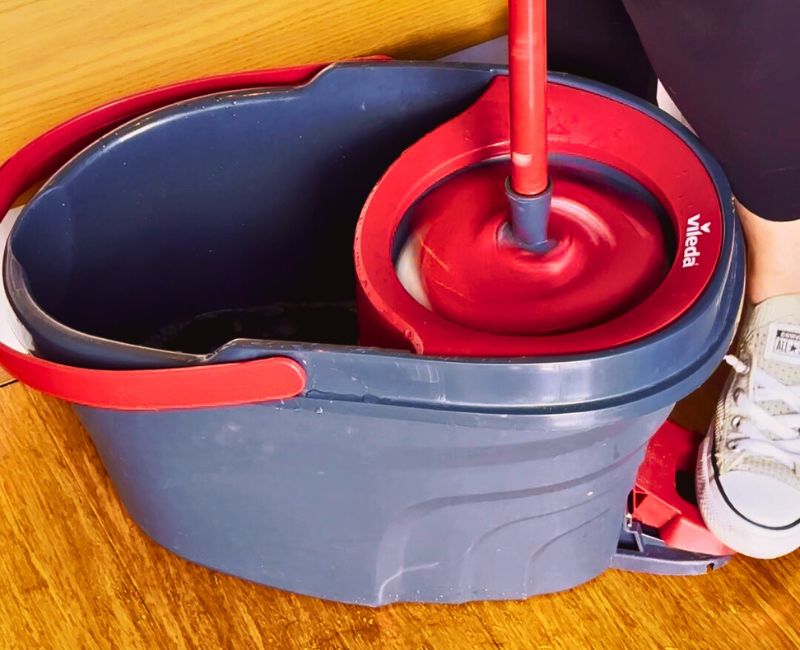 cleaner using a spin mop to clean bamboo flooring
