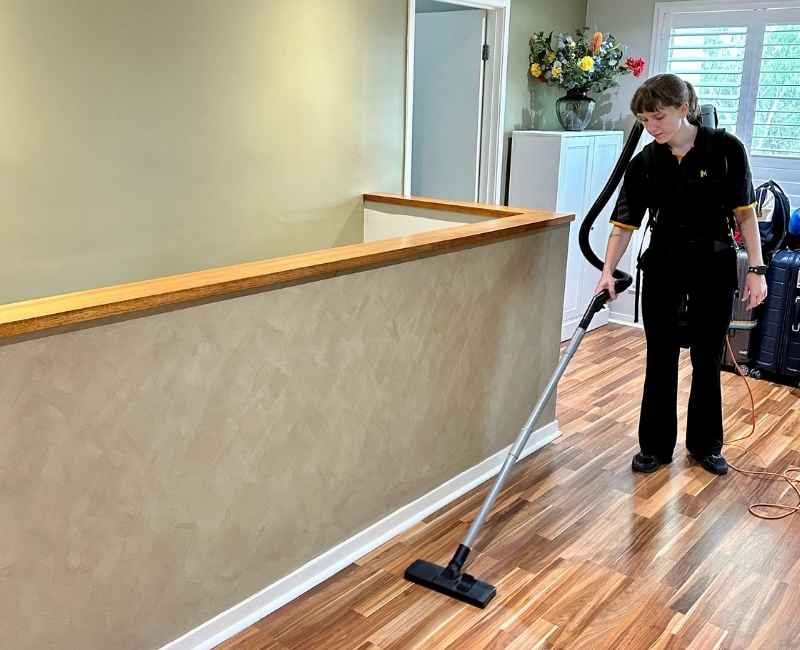 Maid2Match Brisbane house cleaner Kayleigh vacuuming the floor
