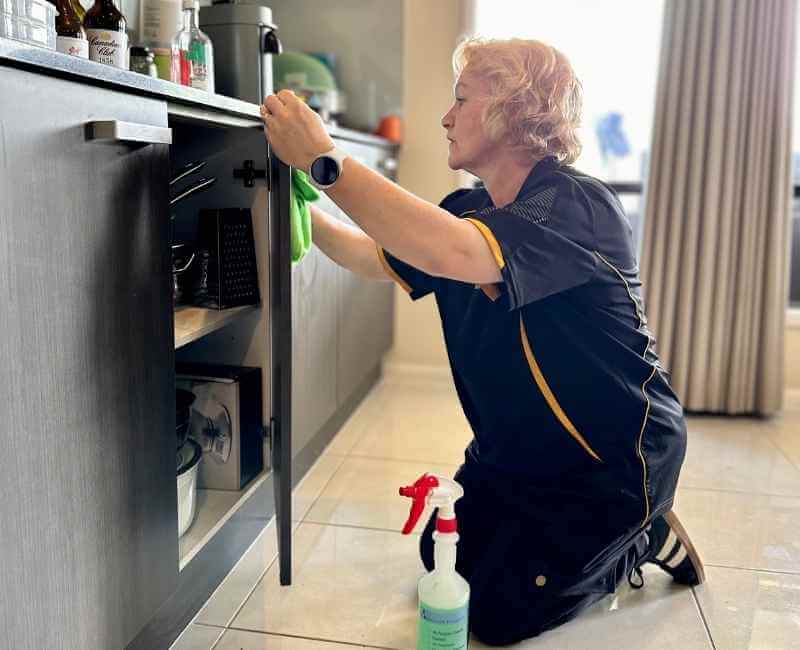 Gold-Coast-DVA-cleaner-Nicola-cleaning-kitchen-cabinets Maid2Match Gold Coast professional DVA cleaner Nicola cleaning kitchen cabinets