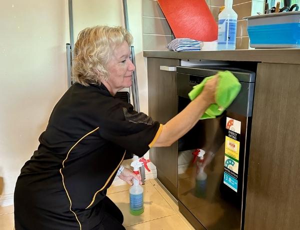 Nicola cleaning oven exterior
