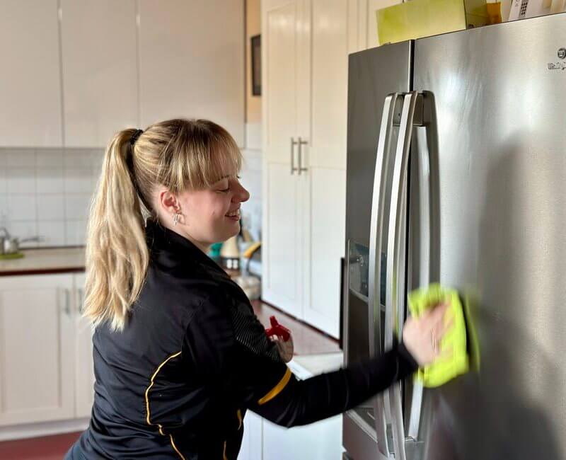 DVA-cleaner-Grace-cleaning-fridge Maid2Match Geelong professional house cleaner Grace cleaning the fridge