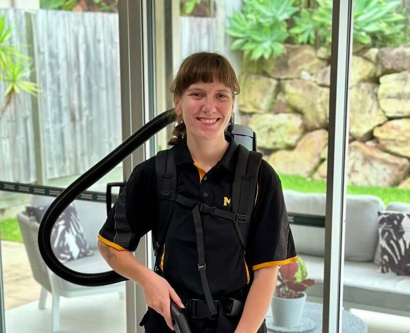 professional-NDIS-cleaner-Kayleigh-holding-vacuum-smiling Maid2Match Brisbane trained professional NDIS cleaner Kayleigh