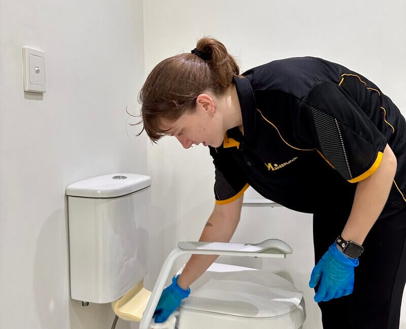 professional-NDIS-cleaner-Kayleigh-cleaning-toilet Maid2Match Brisbane professional house cleaner and NDIS cleaner Kayleigh cleaning toilet