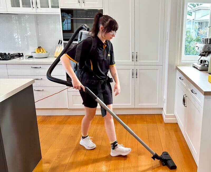 Brisbane-DVA-cleaner-vacuuming-wooden-floors Brisbane house cleaner Tullie vacuuming wooden floor
