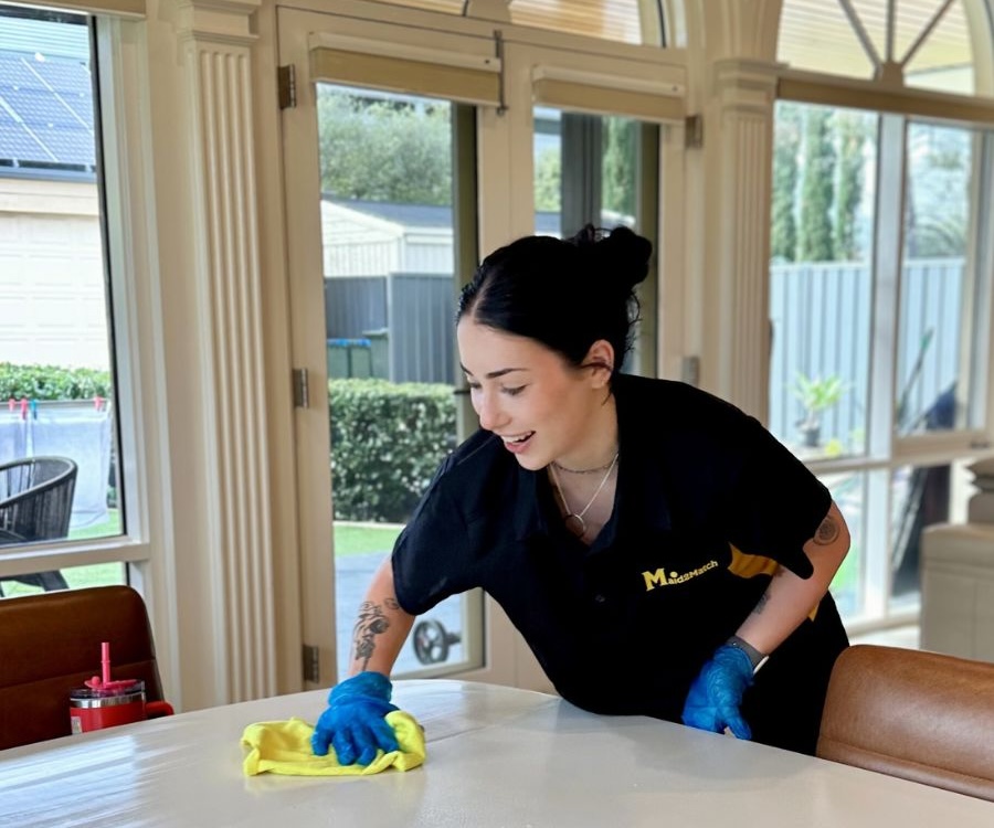 Maid2Match experienced cleaner cleaning a table in a property