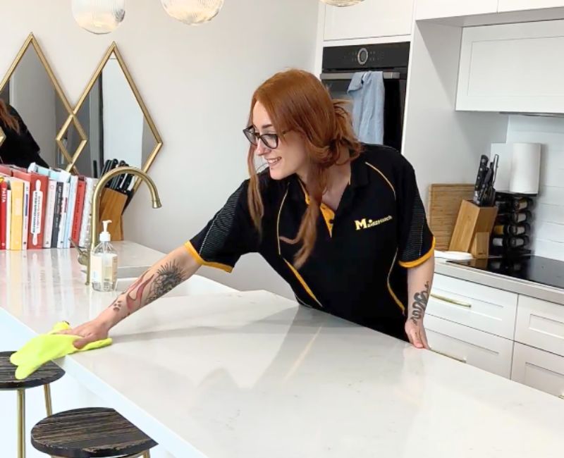 Maid2Match professionally trained house cleaner cleaning a benchtop