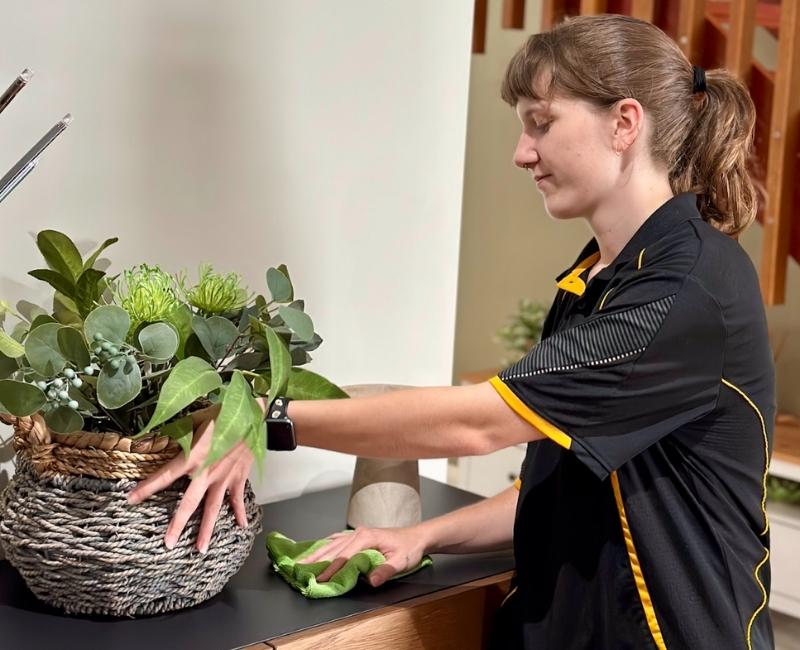 Maid2Match expert house cleaner Kayleigh cleaning around living area
