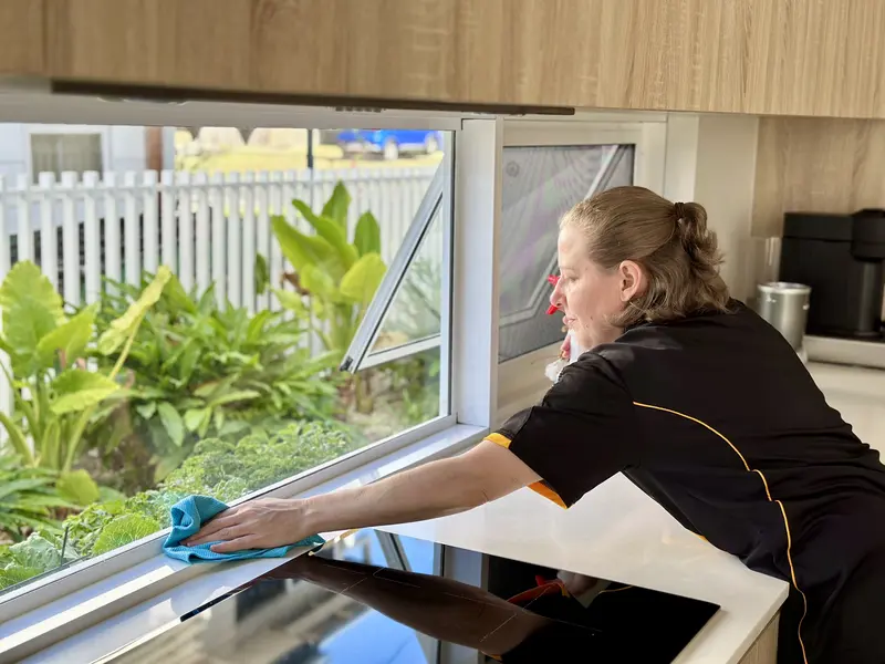 Maid2Match Brisbane professional house cleaner Nicole cleaning window