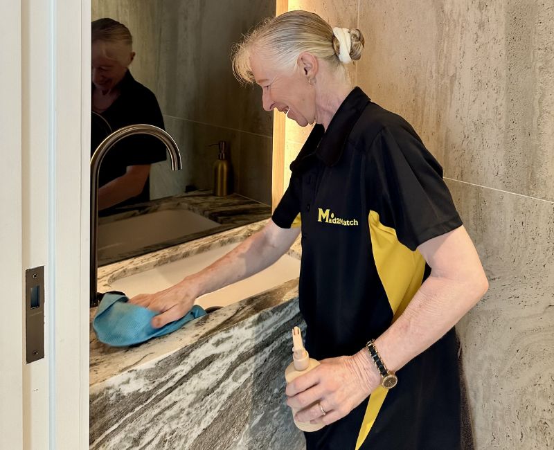Maid2Match Gold Coast professional house cleaner cleaning marble surface in a bathroom