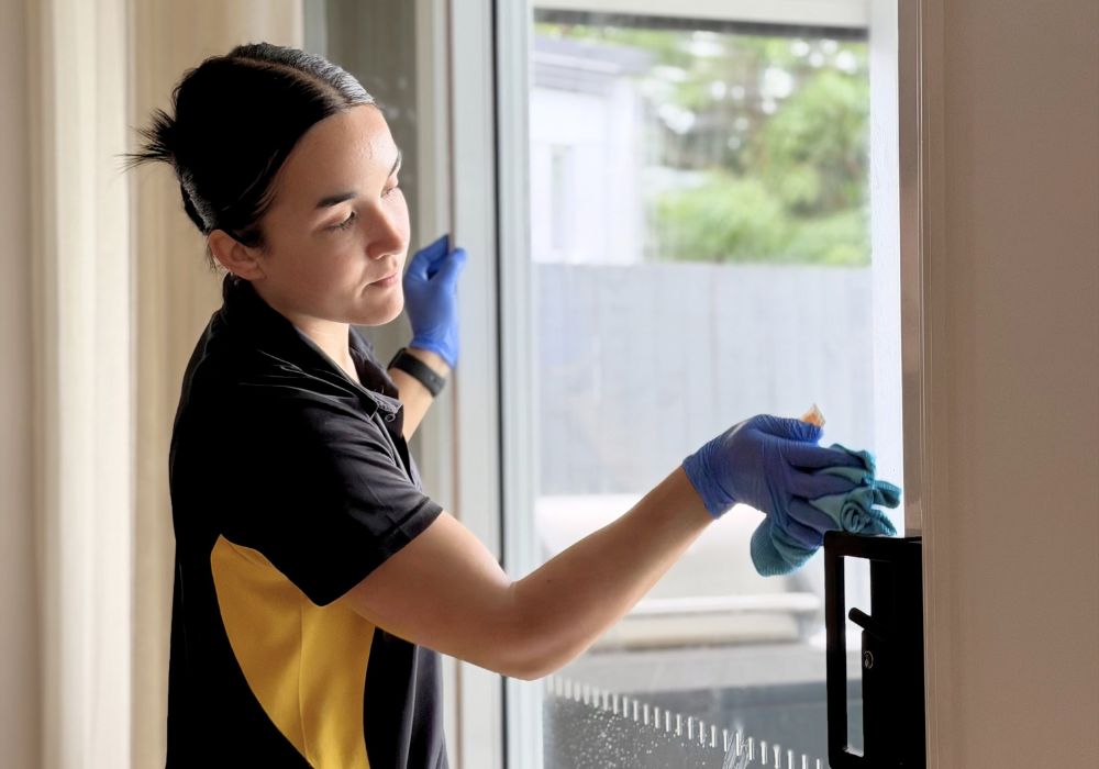 Maid2Match-fully-vetted-house-cleaner-cleaning-interior-glass-door Maid2Match Brisbane fully vetted expert and friendly house cleaner cleaning interior glass door