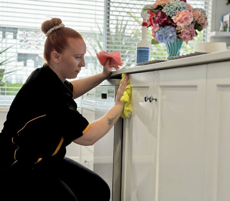 Maid2Match friendly house cleaner cleaning kitchen cabinets