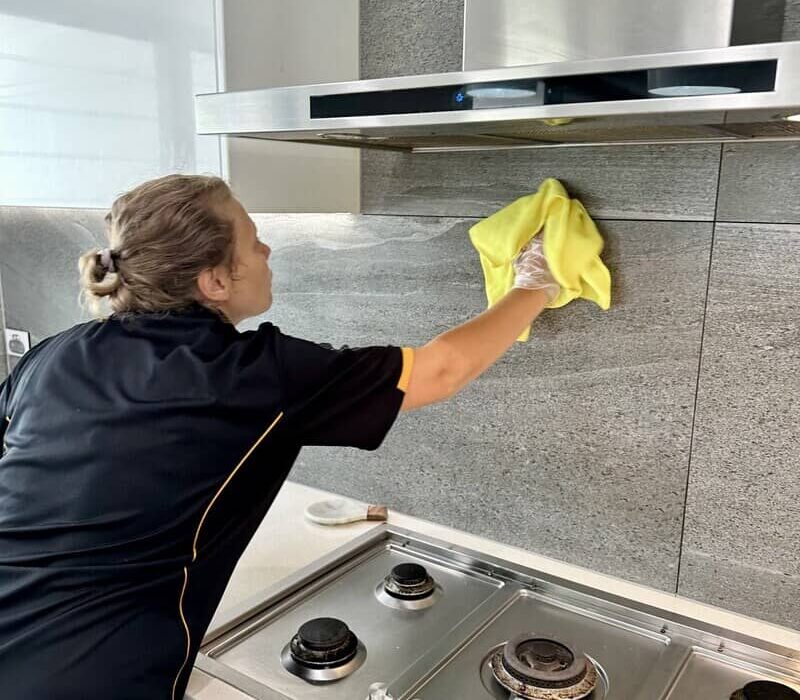 house cleaner Acama cleaning backsplash in the kitchen