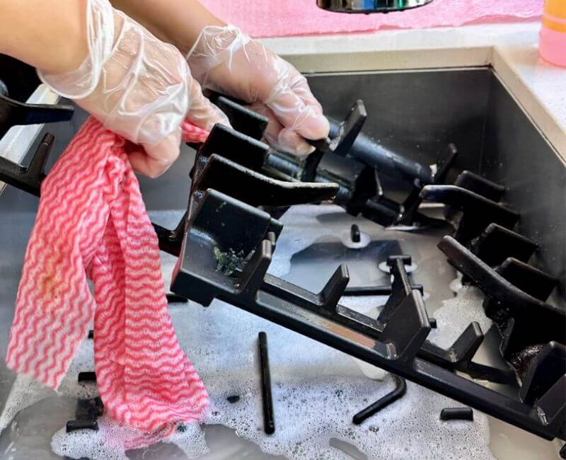 Maid2Match experienced house cleaner washing stove top grates