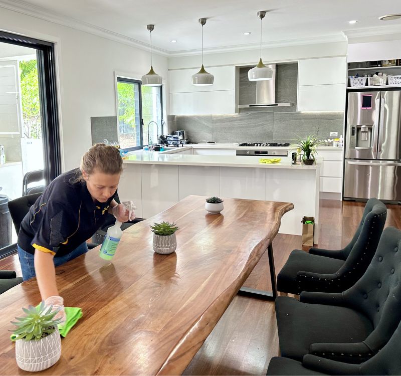 Maid2Match house cleaner Acama cleaning dining table in kitchen dining area