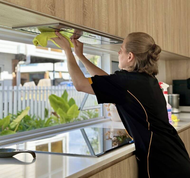 Maid2Match professional house cleaner Nicole cleaning rangehood in the kitchen