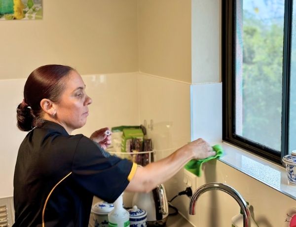 Maid2Match professional house cleaner Sharlene cleaning around kitchen sink
