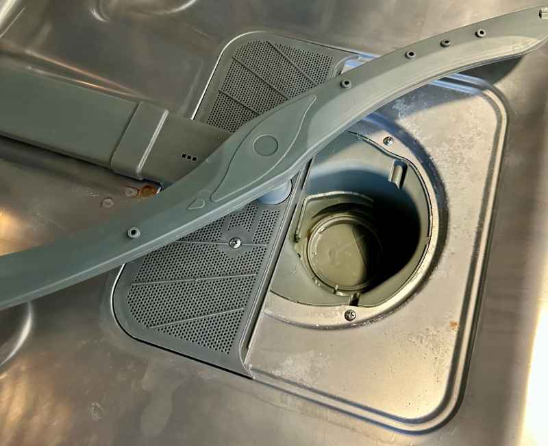 Close-up of a dirty dishwasher drain