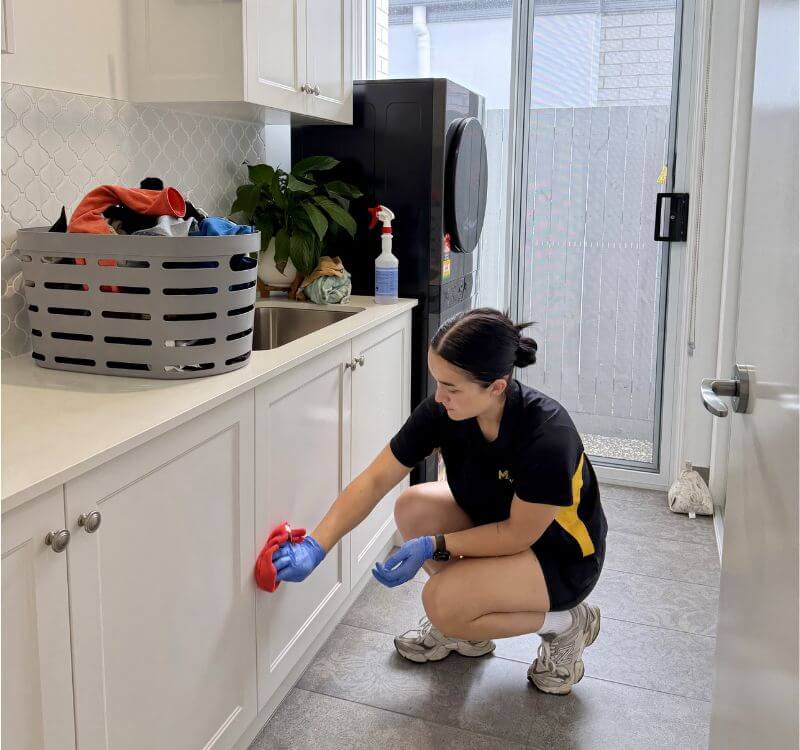 Maid2Match house cleaner cleaning exposed surfaces in laundry room