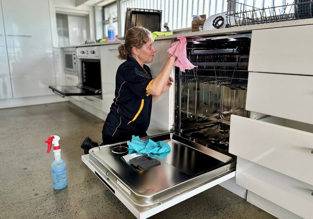 dishwasher-not-cleaning-dishes-solutions Maid2Match house cleaner Nicole deep cleaning a dishwasher during a house clean