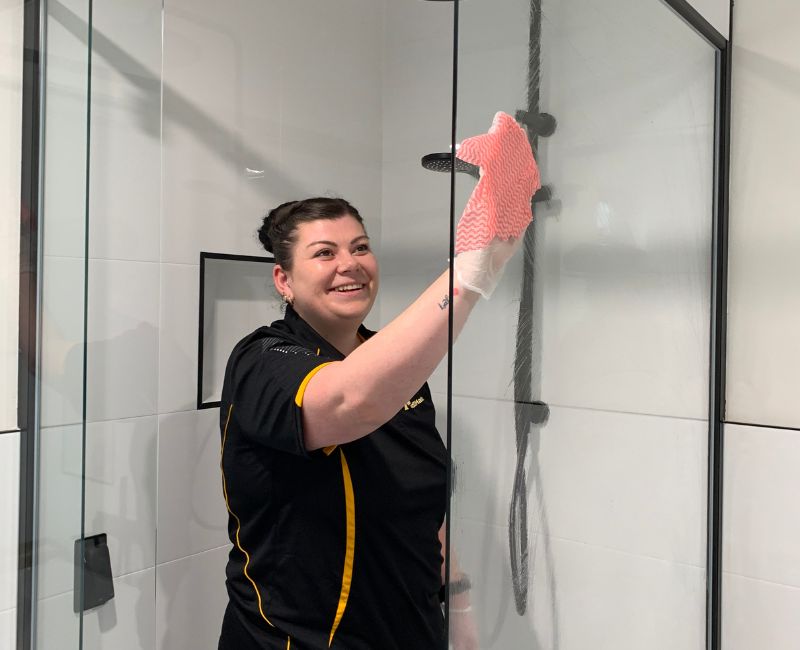 Maid2Match friendly and trusted house cleaner cleaning shower glass