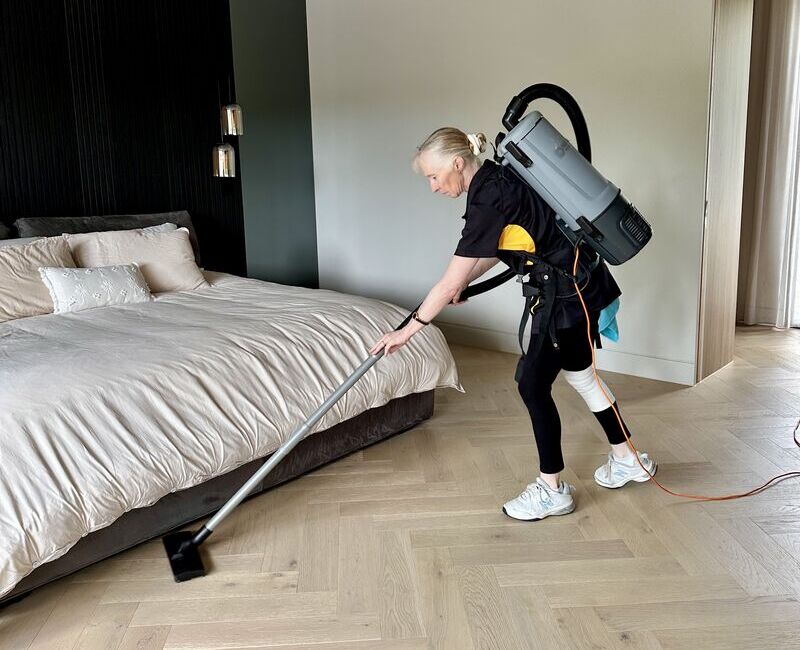 Maid2Match Gold Coast house cleaner Lisa vacuuming in the bedroom area.