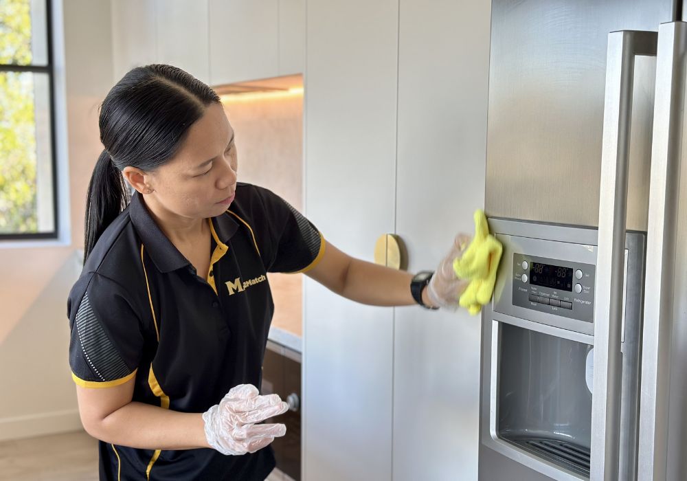 stay-or-leave-when-cleaning-feature Maid2Match house cleaner Paige cleaning fridge dispenser with microfibre cloth