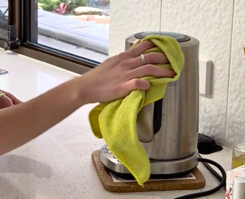 house cleaner Jacinta cleaning an electric stainless steel kettle