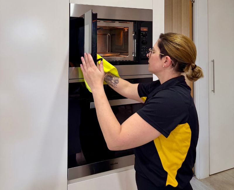 Home cleaner cleaning the inside of a microwave