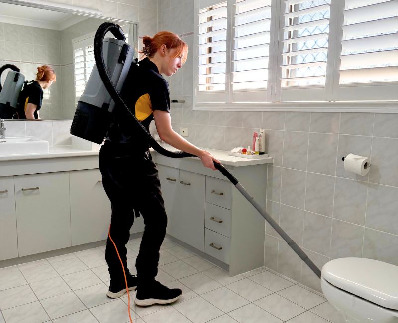 Maid2Match house cleaner Jacinta vacuuming in the bathroom