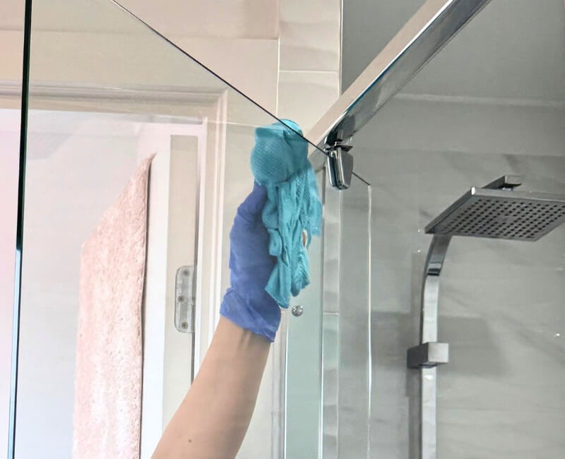 cleaning shower glass with microfibre cloth