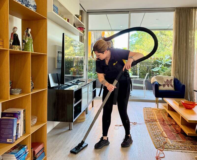 Maid2Match expert house cleaner vacuuming living area