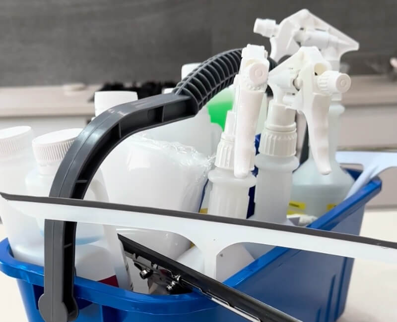 various house cleaning products in a basket