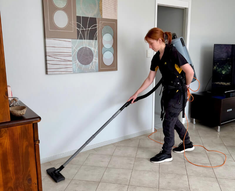 Maid2Match house cleaner in Brisbane vacuuming the floor in the living area