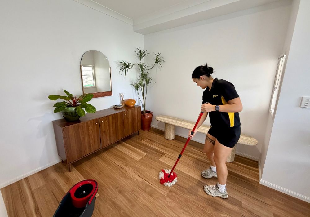 fix-your-streaky-floor-after-mopping Timea mopping wooden floor near entrance