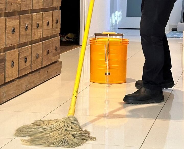 Mopping tile floor with bleach mixture