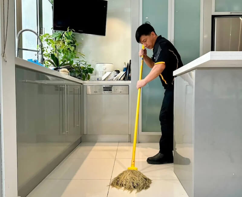 Maid2Match trusted cleaner mopping tiled floor in the kitchen